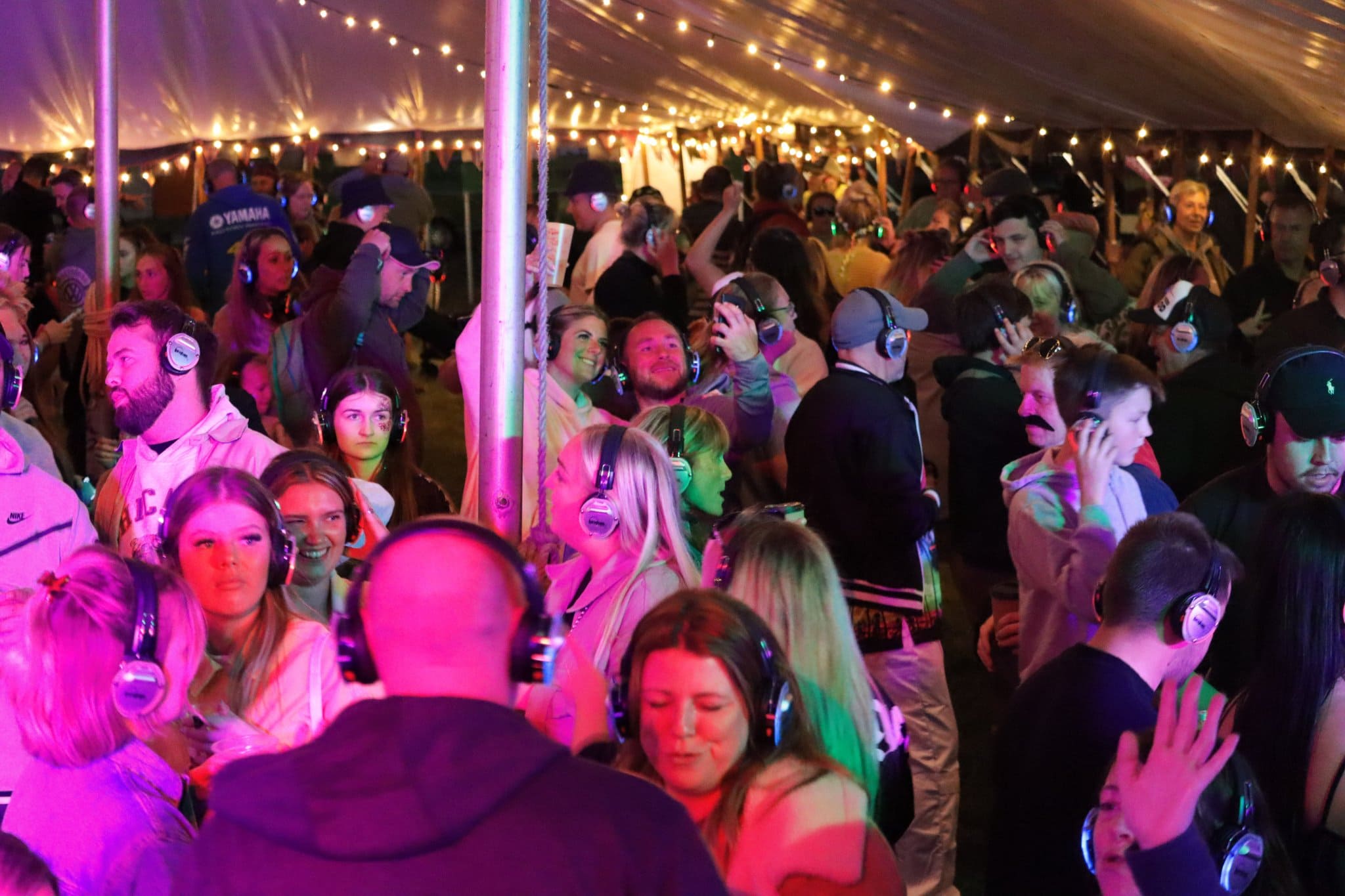 large crowd of people enjoying silent disco