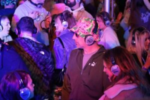 man in bucket hat looking puzzled at the silent disco