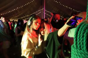 A couple of girls just throwing a pose and enjoying their silent disco