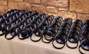 a table full of silent disco headphones set to the blue channel
