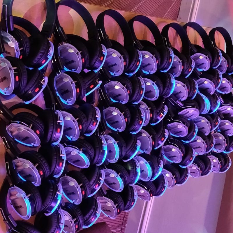 large amount of silent disco headphones in blue