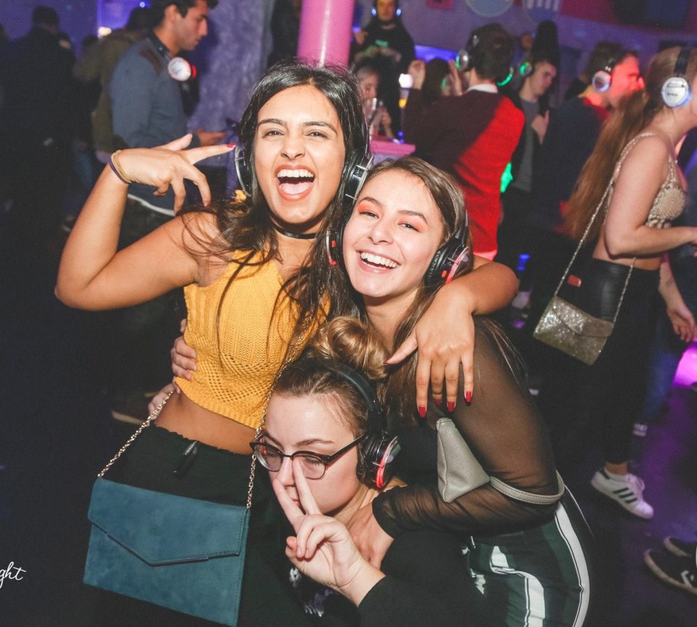 3 ladies having fun at silent disco in camel club huddersfield