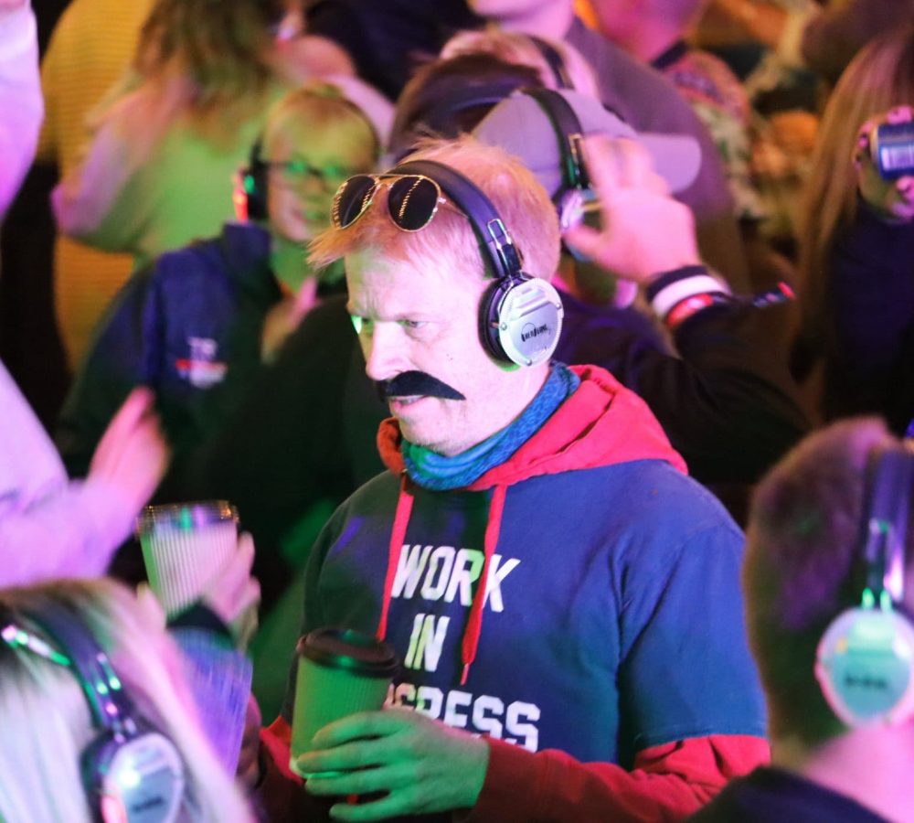 man with moustache enjoying silent disco