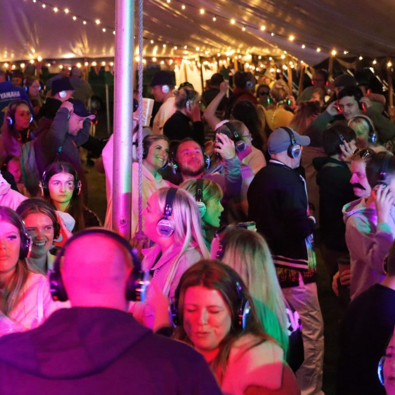 large crowd of people enjoying silent disco